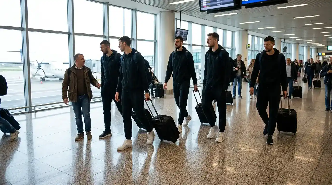 Squadra di pallacanestro italiana con borsoni sportivi attraversa la sala partenze di un aeroporto regionale