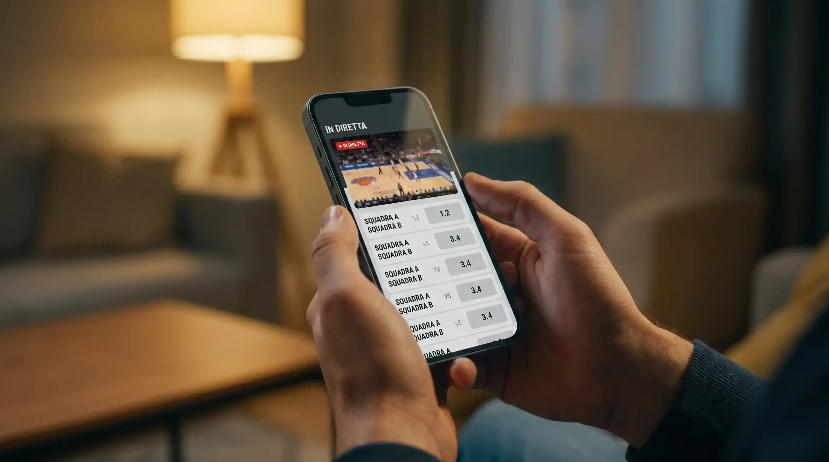 Mano che tiene uno smartphone con applicazione di scommesse sportive aperta su una partita di pallacanestro in diretta